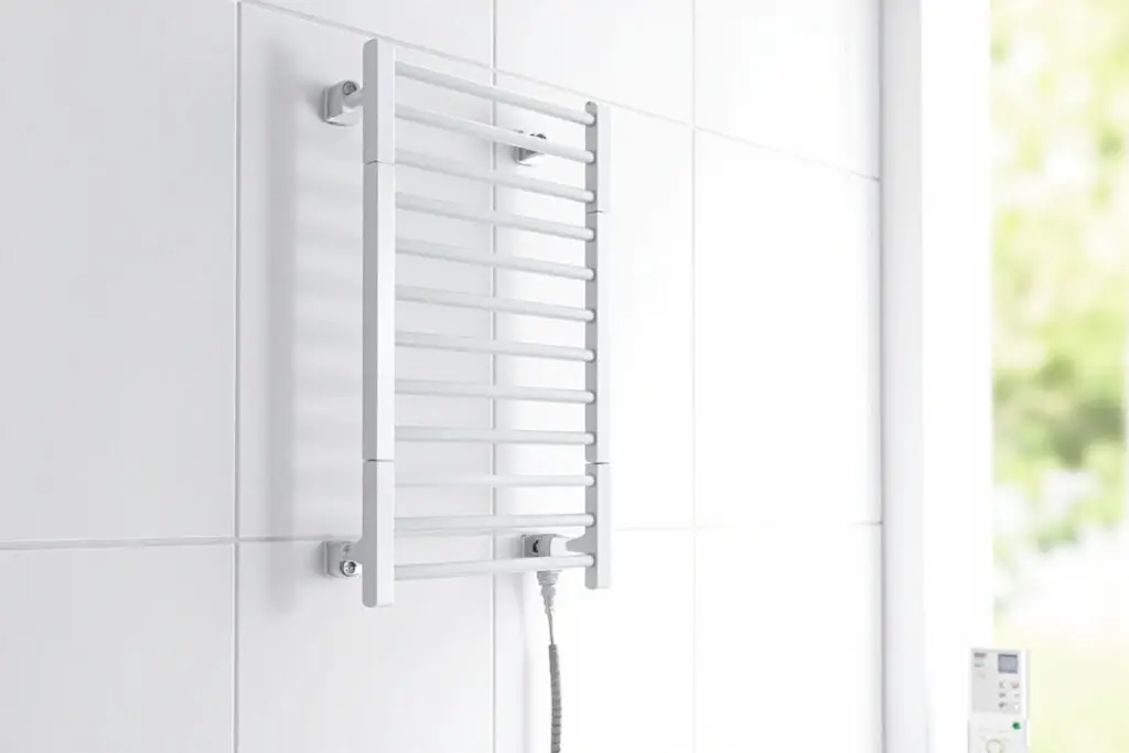 Wall-mounted electric heated towel rack with 5 straight parallel bars in a modern luxury hotel bathroom - Heated Towel Rack and towel warmer for US B2B buyers