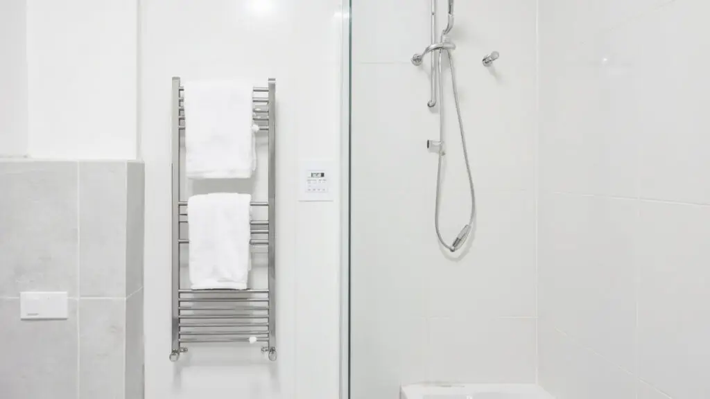Hotel bathroom with heated towel rack and digital programmable timer switch - commercial 24/7 use energy guide