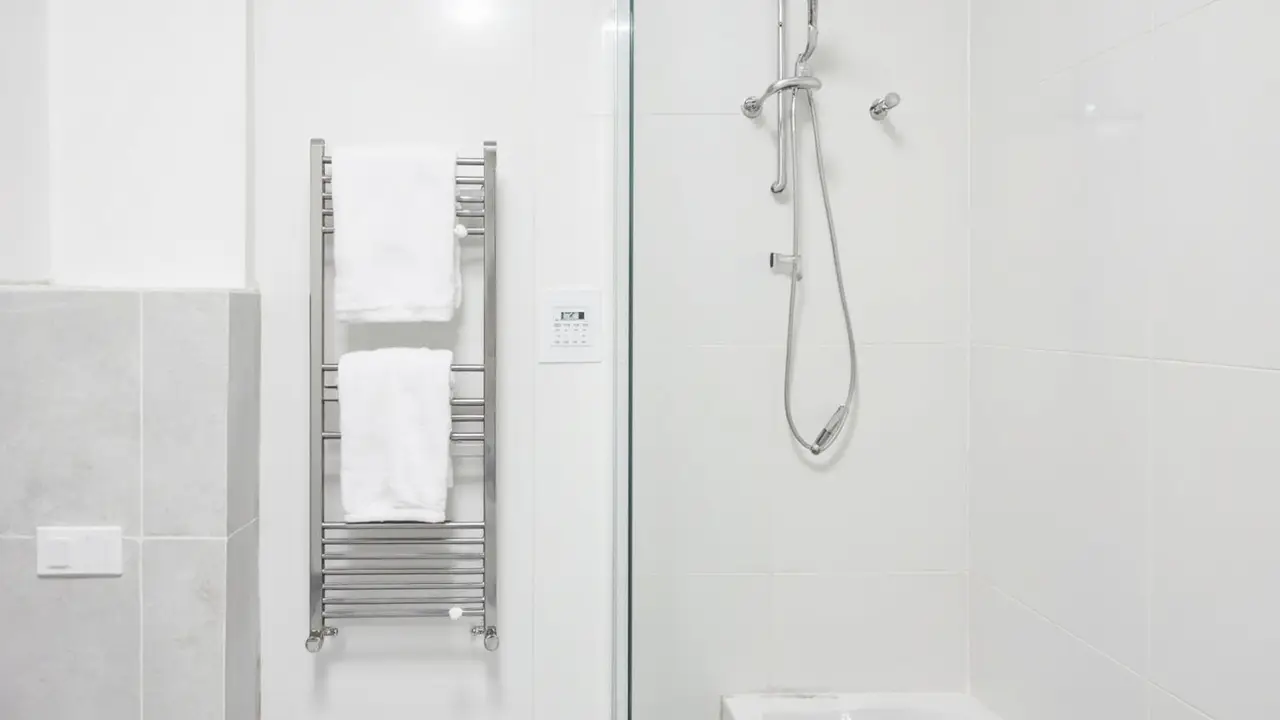 Hotel bathroom with heated towel rack and digital programmable timer switch - commercial 24/7 use energy guide